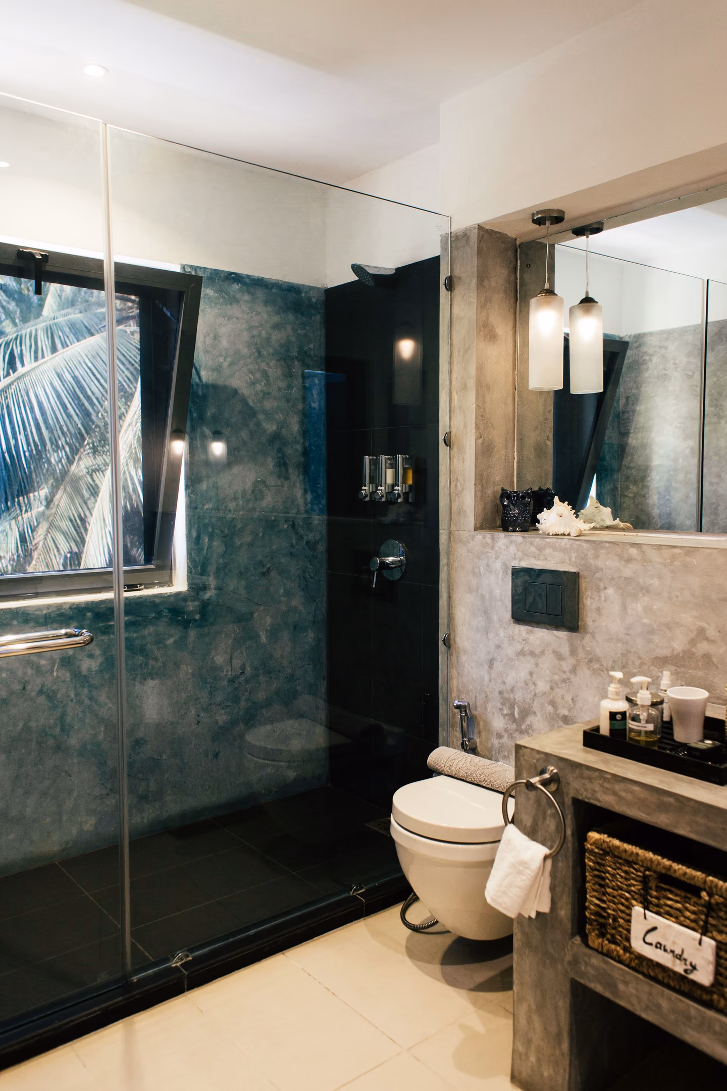 Bright bathroom with a glass shower, vanity, and neutral finishes