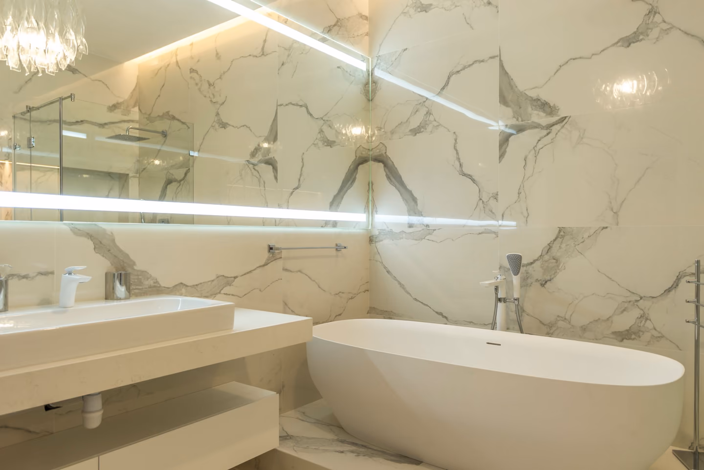 Wide view of a refined modern primary bathroom interior