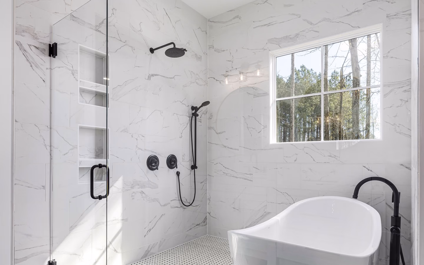Luxury modern bathroom with a freestanding tub, glass shower, black fixtures, and natural light