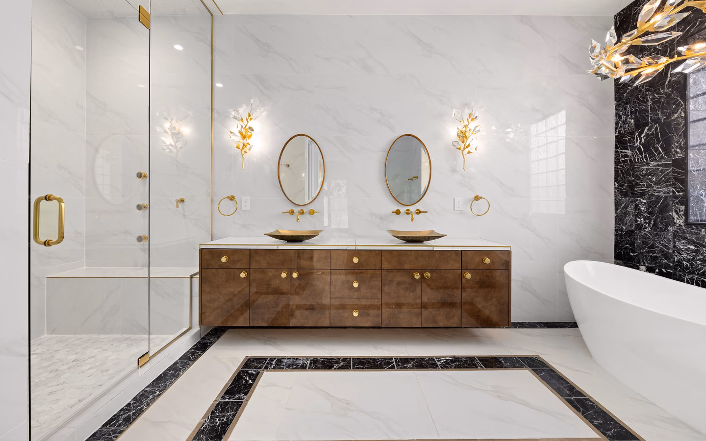 Refined traditional bathroom with a dark wood vanity, marble surfaces, and warm metal details