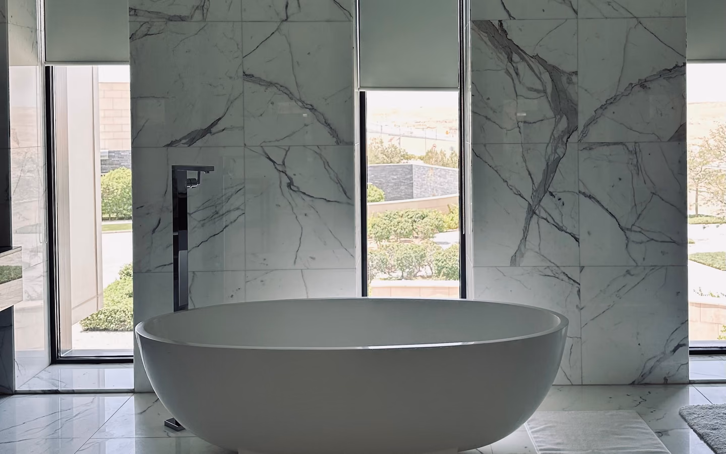 Serene spa-inspired bathroom with a sculptural freestanding tub and dramatic stone walls