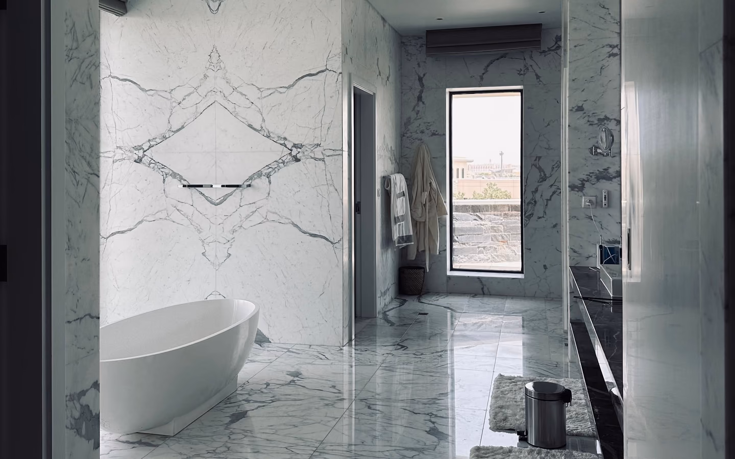 Quiet spa-like bathroom with a freestanding tub, pale marble walls, and natural light