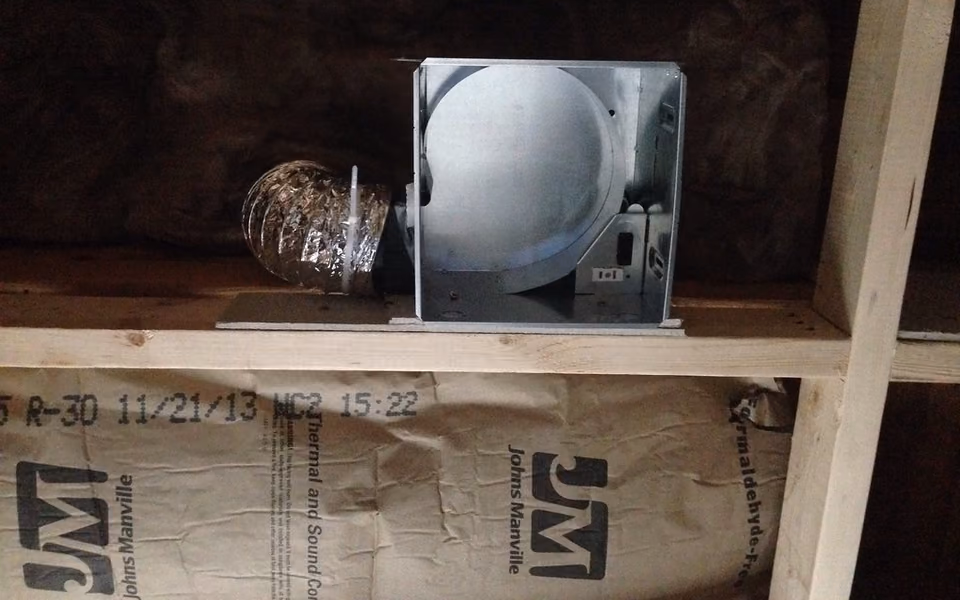 Exhaust fan and light housing installed between bathroom wall studs