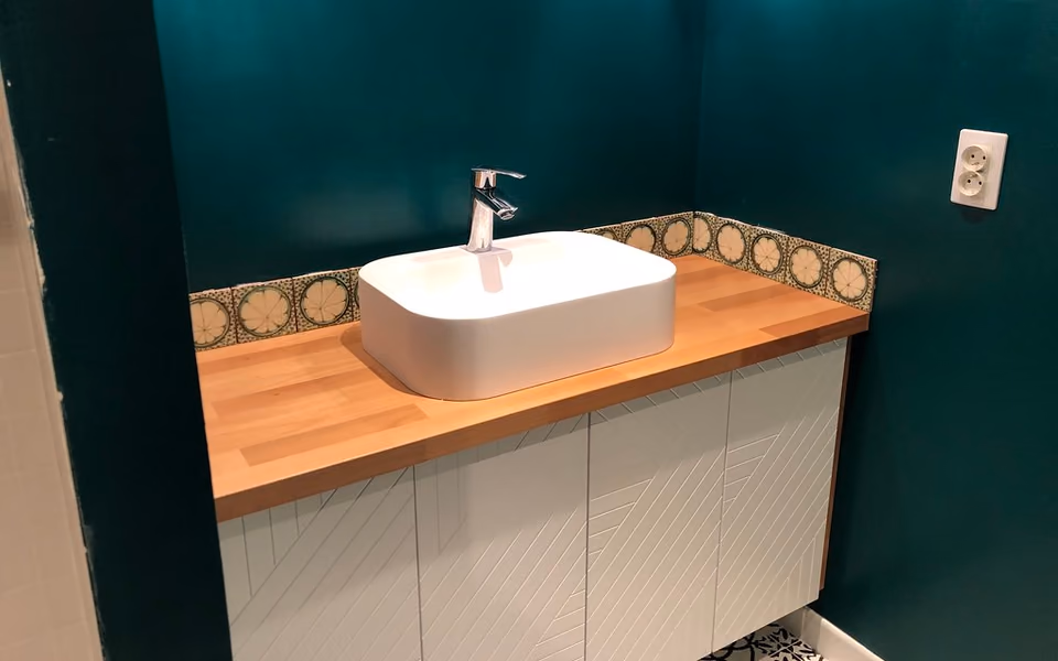 Compact floating vanity with an easy-clean counter and tiled accent wall