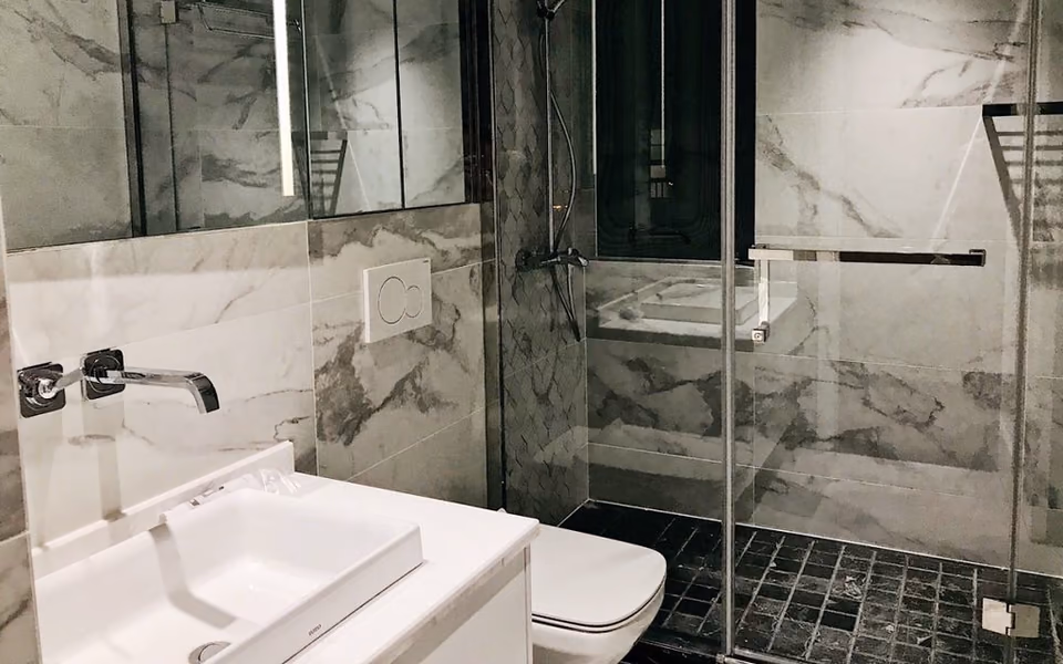 Finished shower enclosure with coordinated wall panels and fixtures