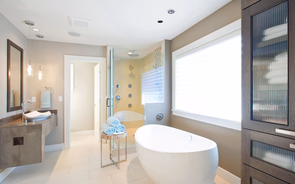 Large primary bathroom with a freestanding tub, open shower, and vanity