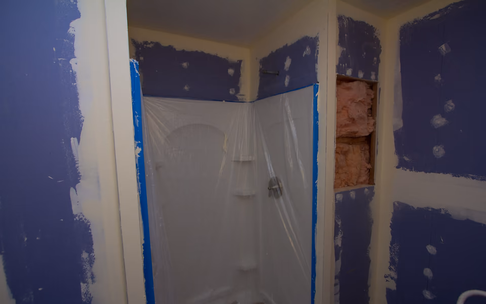 Shower wall opened for a repair during a bathroom renovation