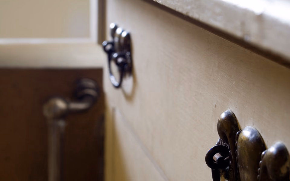 Bathroom cabinet door and hardware providing access below a sink