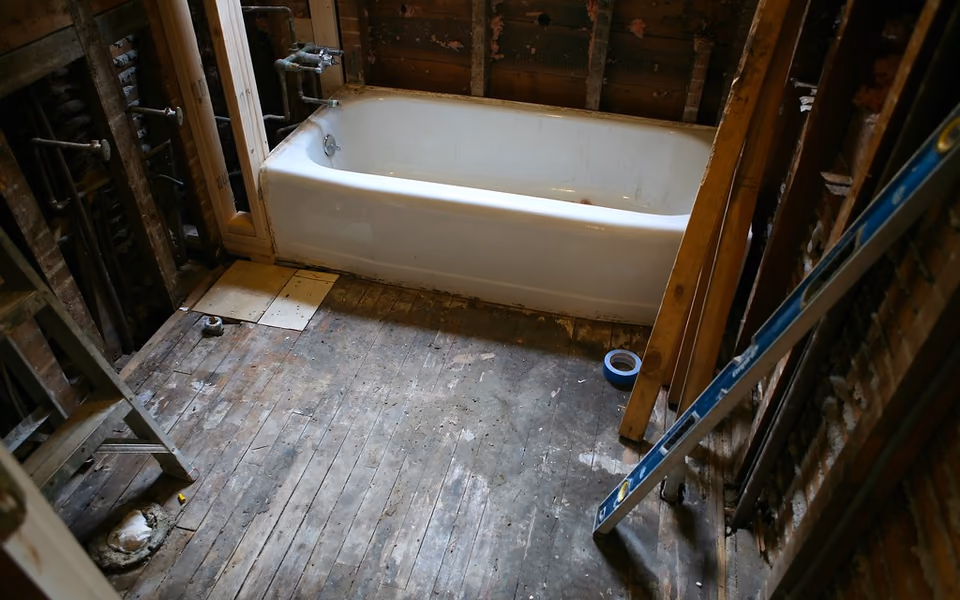 Small bathroom opened during renovation to show its compact footprint