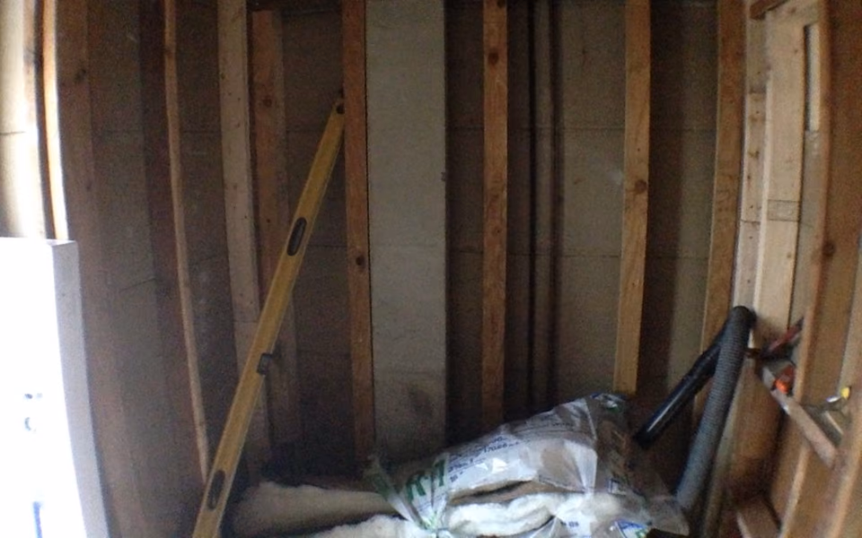 Bathroom wall framing exposed before reinforcement and backer board installation